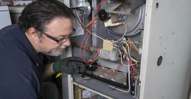 Technician inspecting a furnace