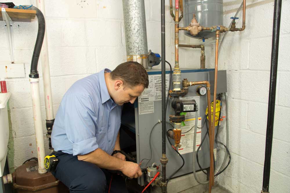 HVAC technician repairing furnace